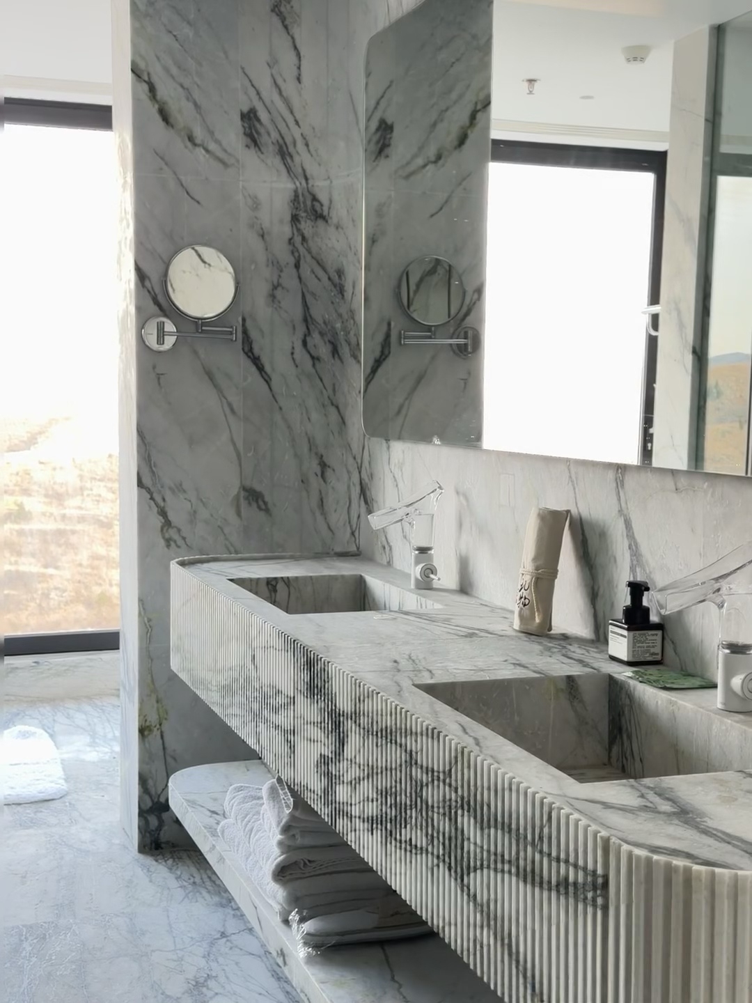 Carved marble double vanity and matching bathroom wall cladding